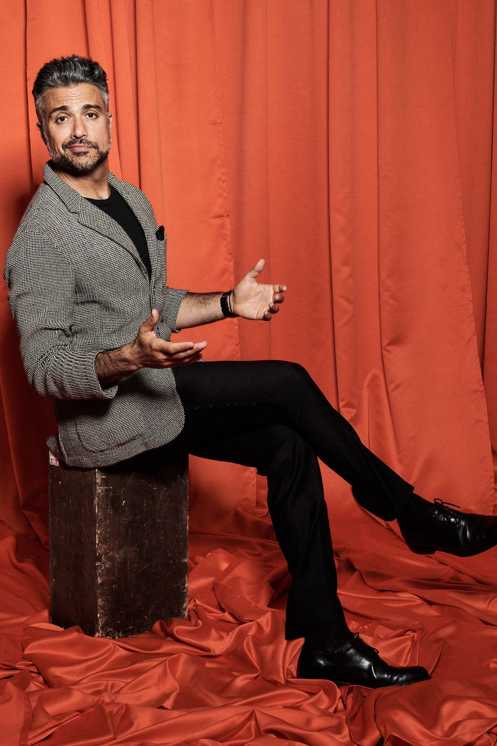 actor jaime camil smirking at the camera for a portrait.