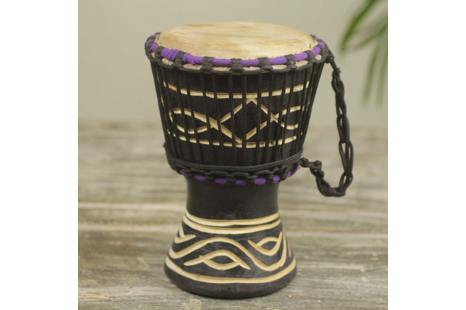 A wooden drum with carved patterns.