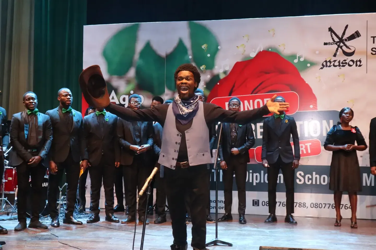 A photo of Victor Ige in the middle of a performance.
