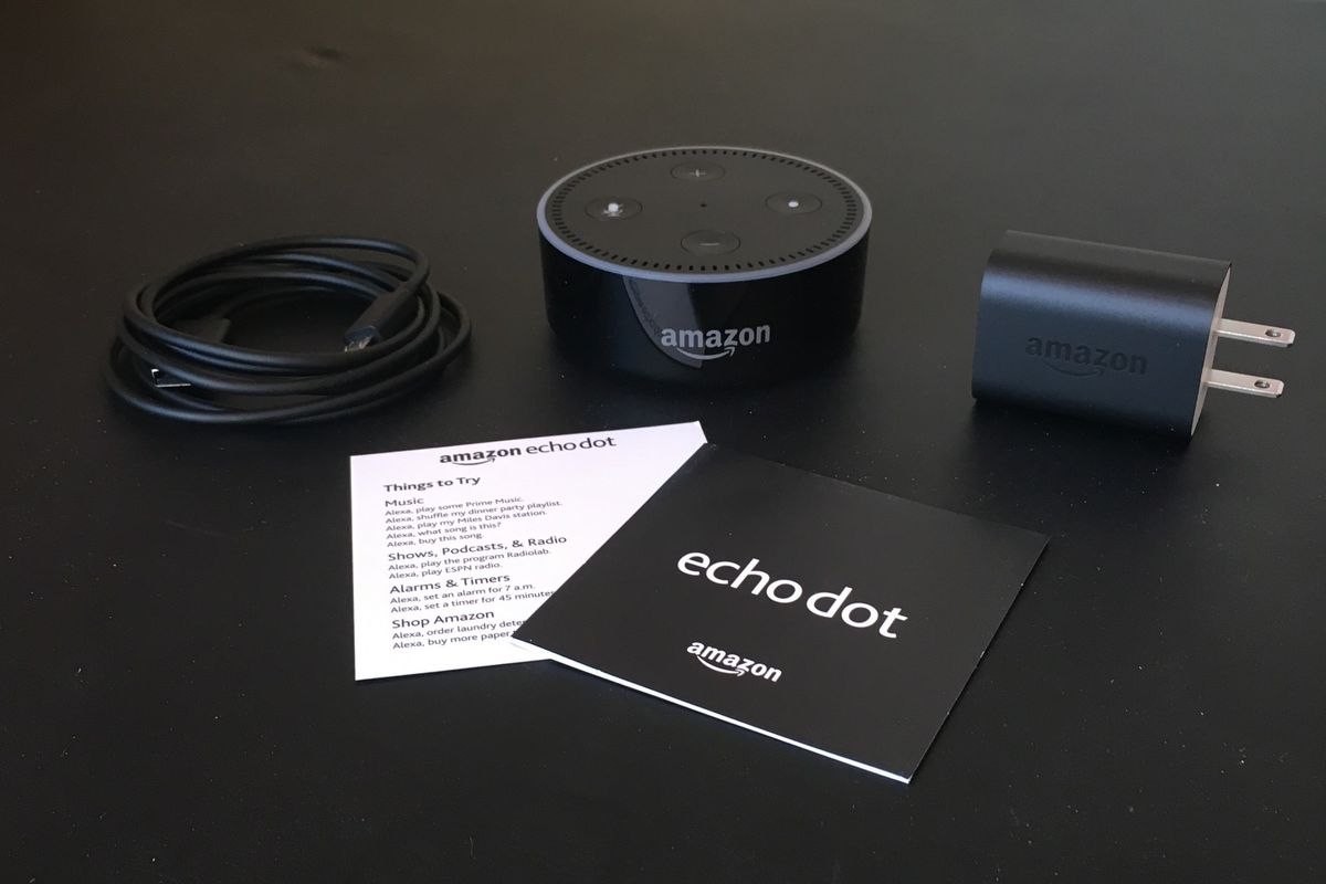 a photo of echo dot 1st gen unboxed on a table