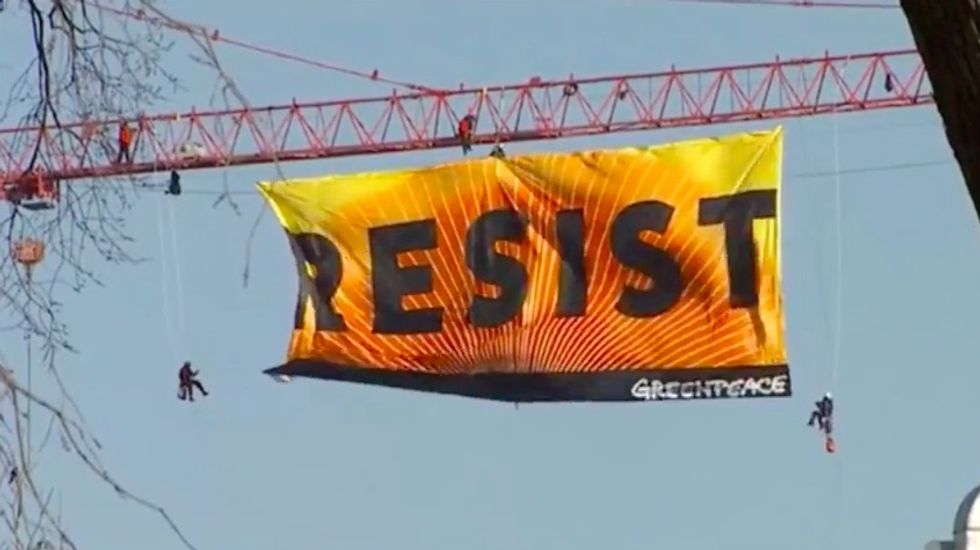 Greenpeace Daredevils Hang Big Beautiful 'RESIST' Banner From Crane Near White House