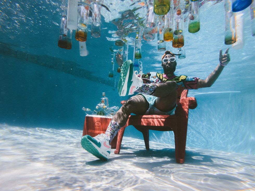 man sitting in chair underwater