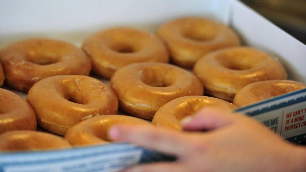 Krispy Kreme is giving away free dozens of its glazed doughnuts with BOGO deal