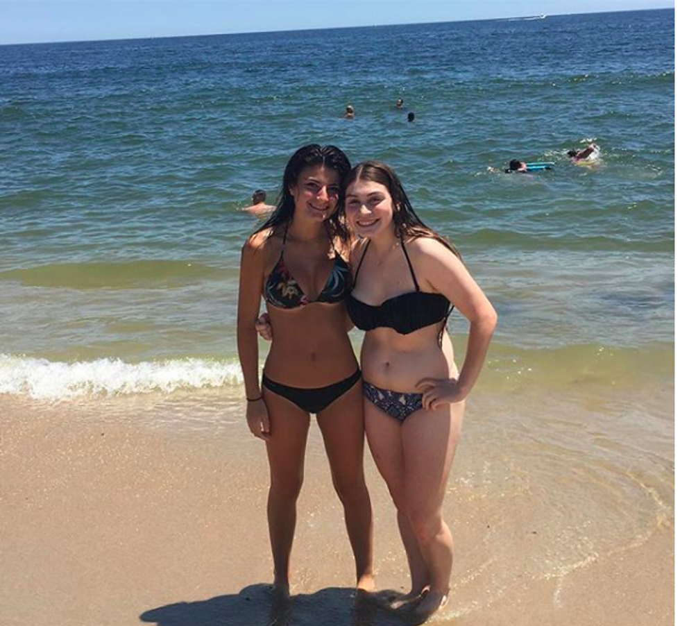 Sarah standing next to her friend on the beach