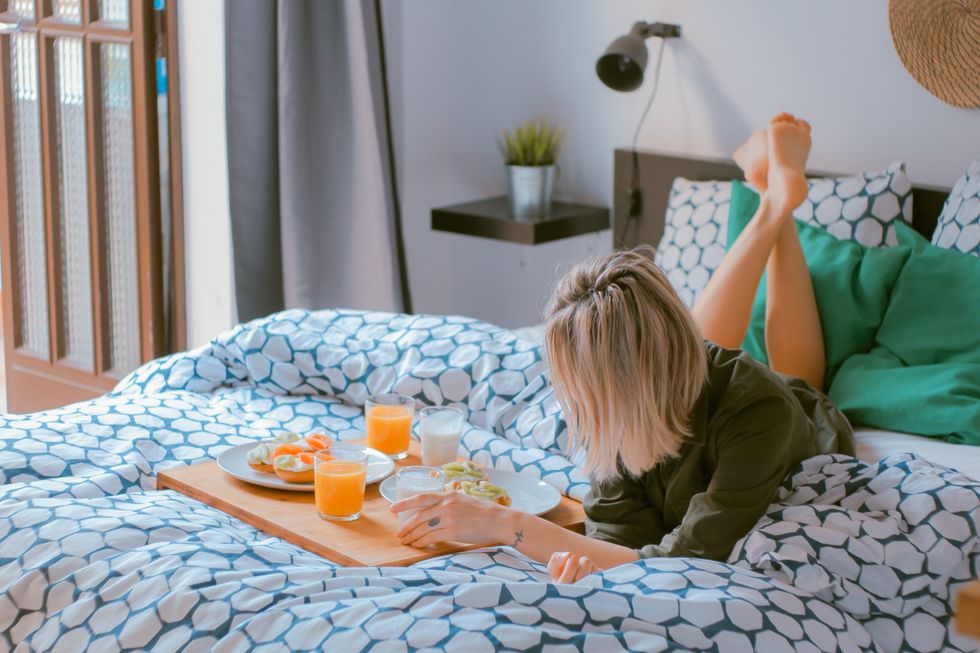 woman eating alone in bed