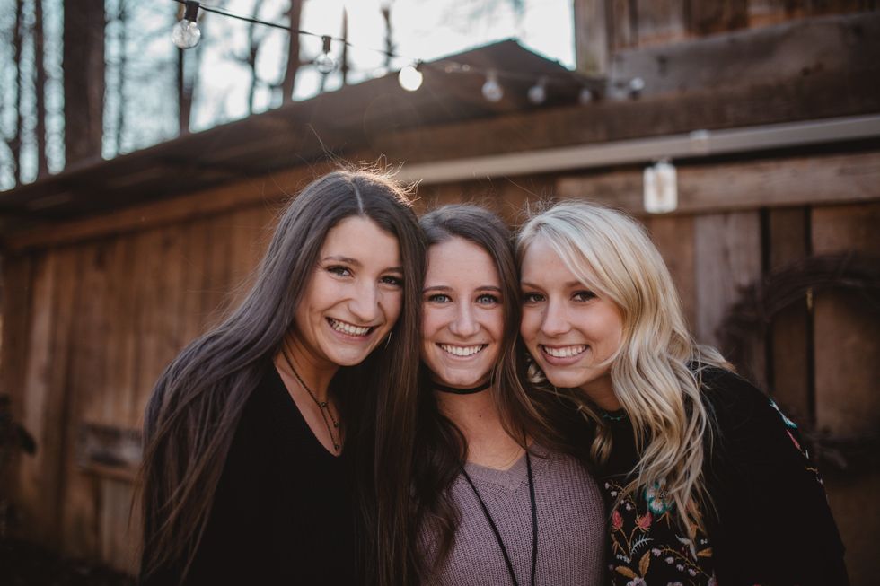 3 friends smiling next to each other