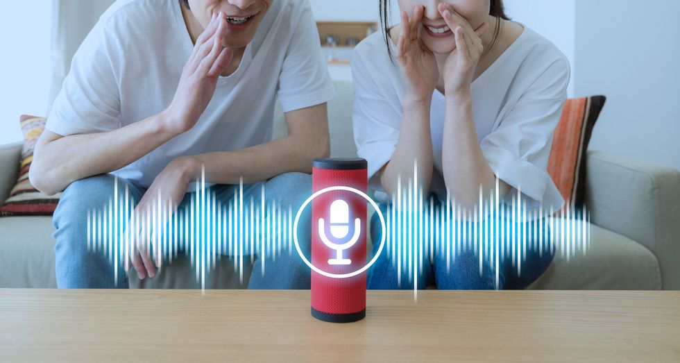 photo of a couple talking to a smart speaker