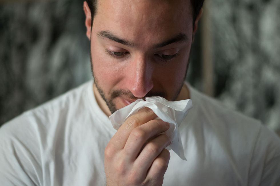 Guy with tissue near his face