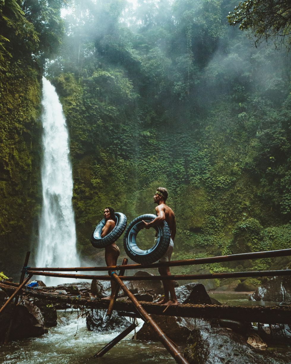 https://www.pexels.com/photo/two-person-carrying-black-inflatable-pool-float-on-brown-wooden-bridge-near-waterfalls-1020016/