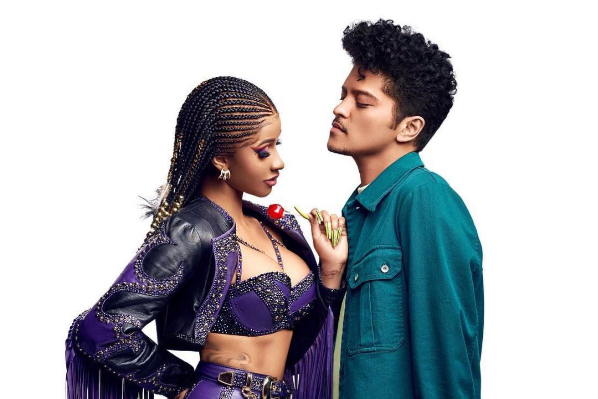 cardi b in purple rhinestone outfit staring at Bruno Mars