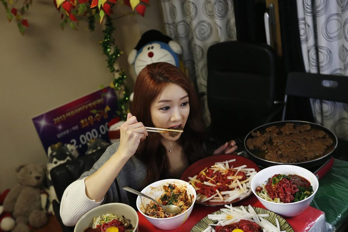 popdust asian woman eating online mukbang