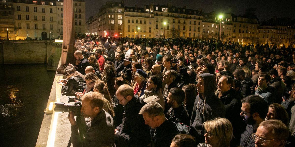 WATCH Onlookers kneel, sing 'Ave Maria' as they watch the Notre Dame