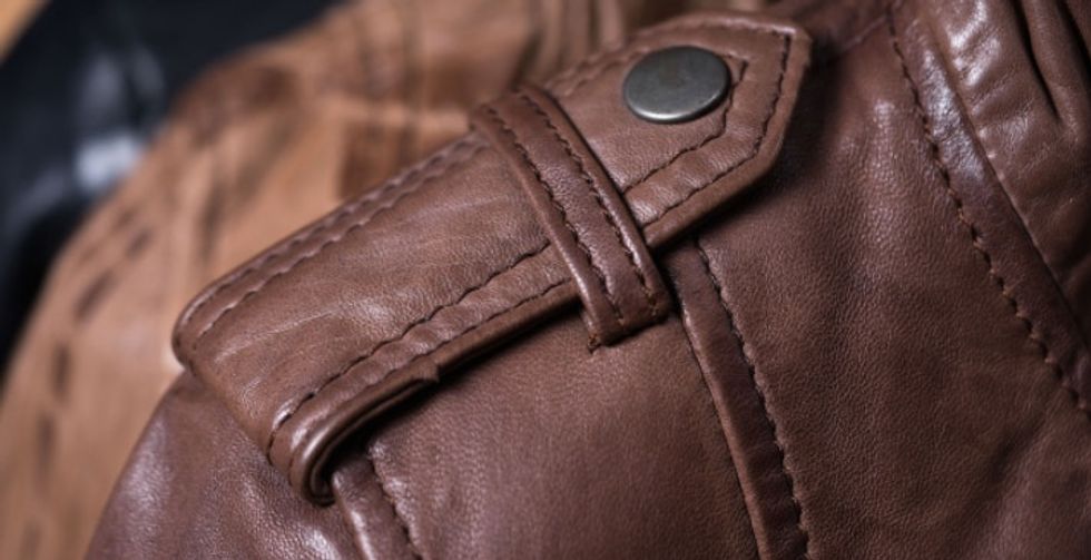Woman discovers the shoulder button on jackets is for holding hand bags in place.