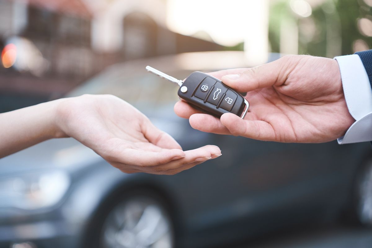 stock photo of car key being handed over