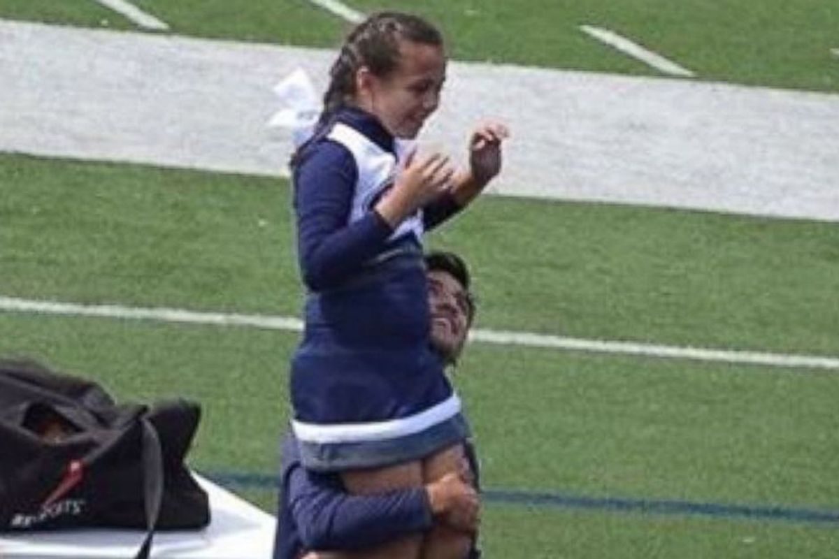 A 9-yr-old cheerleader’s veteran dad couldn't help with her routine, so a high schooler ran to her side
