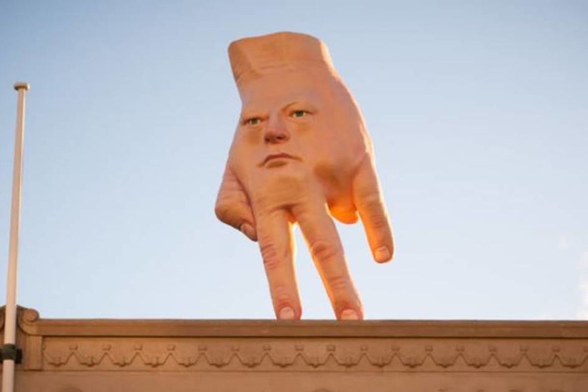 A 16-foot hand-face statue overlooking Christchurch, New Zealand is impossible to ignore