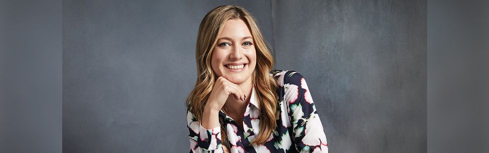 Actress Zoe Perry smiles broadly as she poses during a show preview.