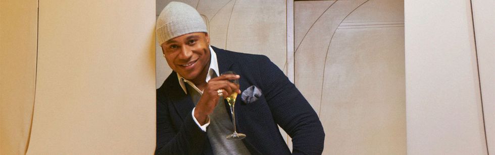 LL Cool J wears a knit cap and sips champagne.
