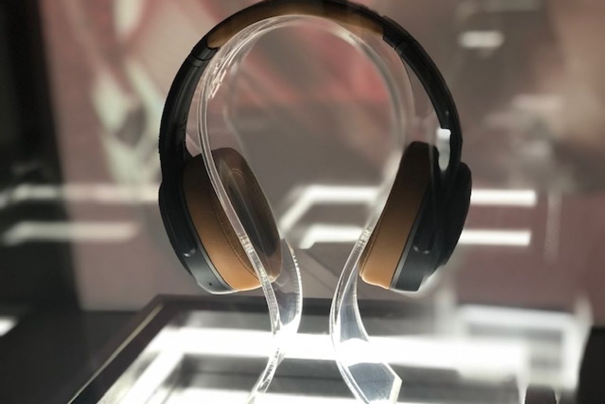 Black and tan headphones on a glass table