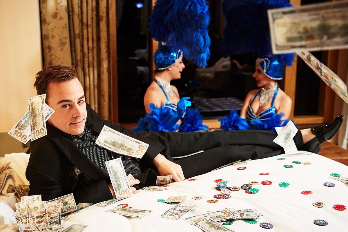 Sean Murray surrounded by money and poker chips in black outfit