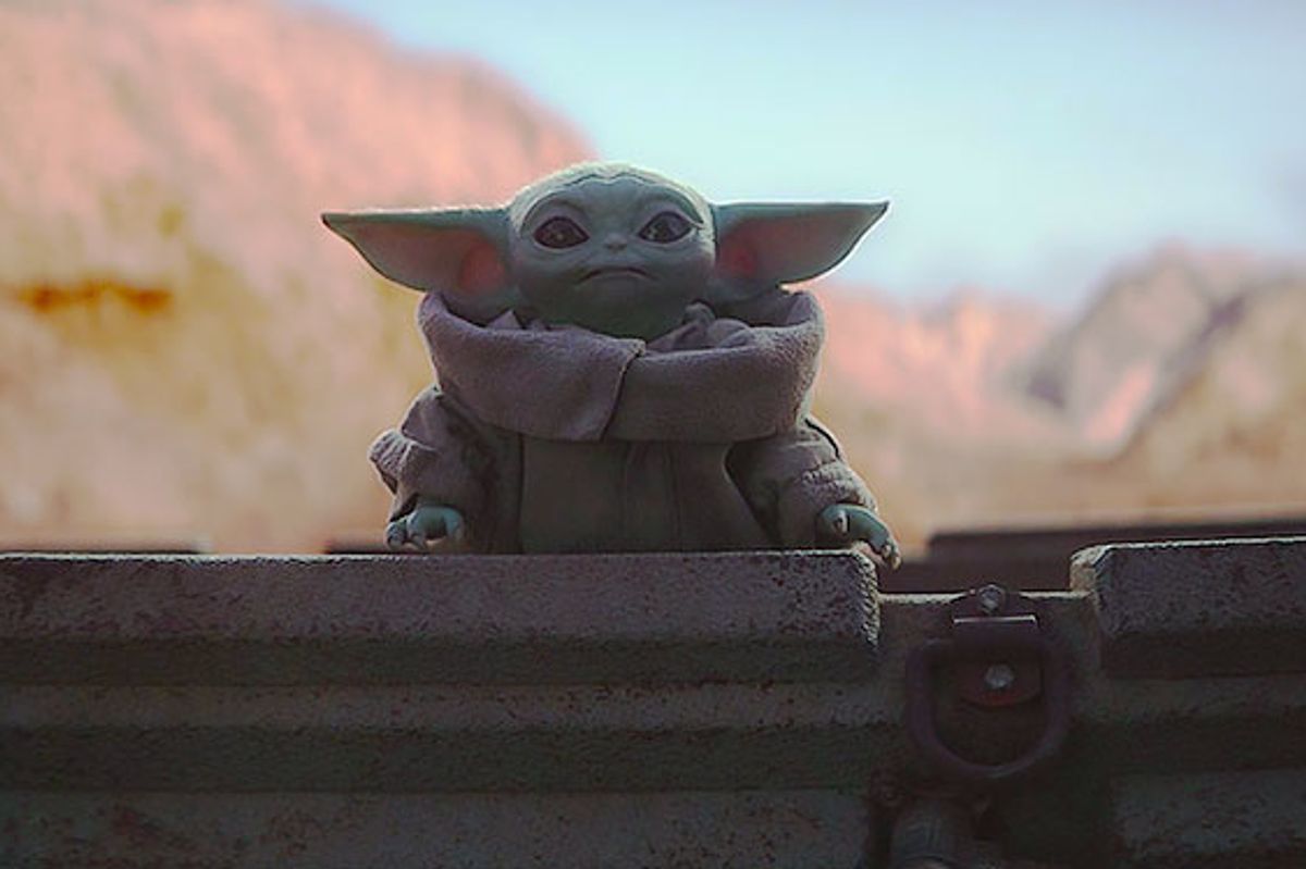 The adorable Baby Yoda looks worried for the Mandalorian