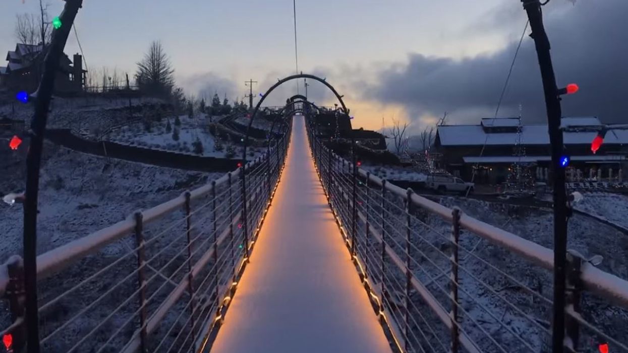 See a bird's eye view of the snow-covered Smoky Mountains in Gatlinburg SkyBridge video