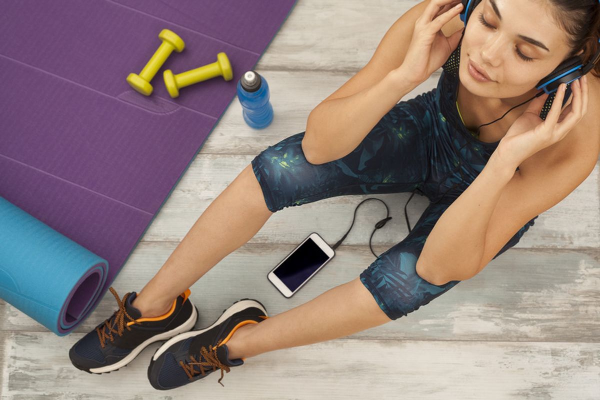 Woman after working out listening to music on aaptiv