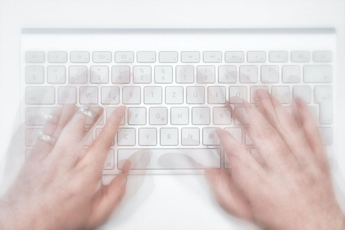 hands typing on new wireless mac apple keyboard