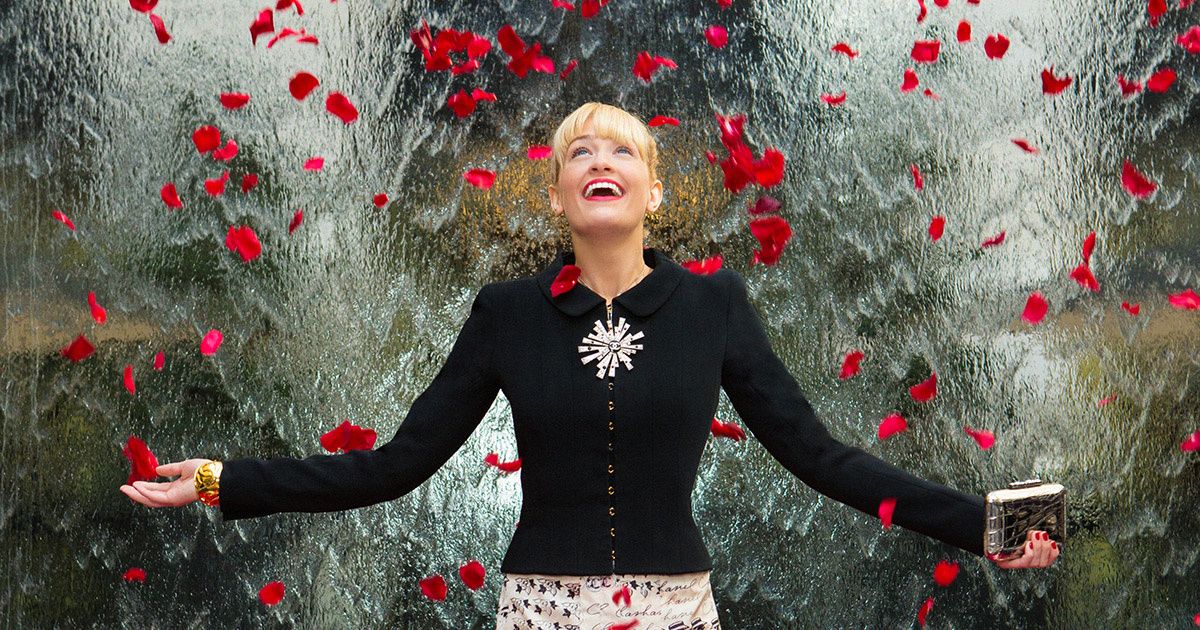 Beth Behrs of The Neighborhood with falling rose petals.