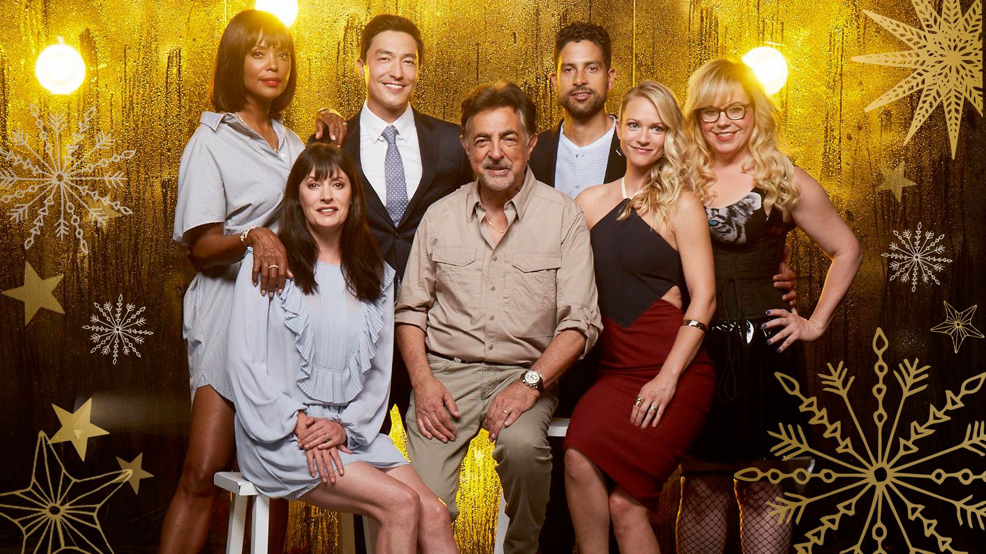 The cast of Criminal Minds standing in front of a golden and starry background