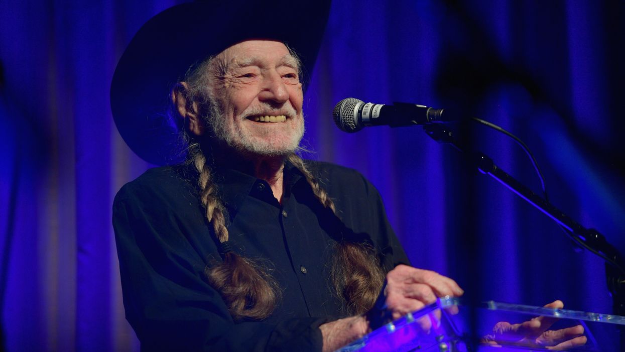 Willie Nelson helps raise money for making masks by signing the ones gifted to him