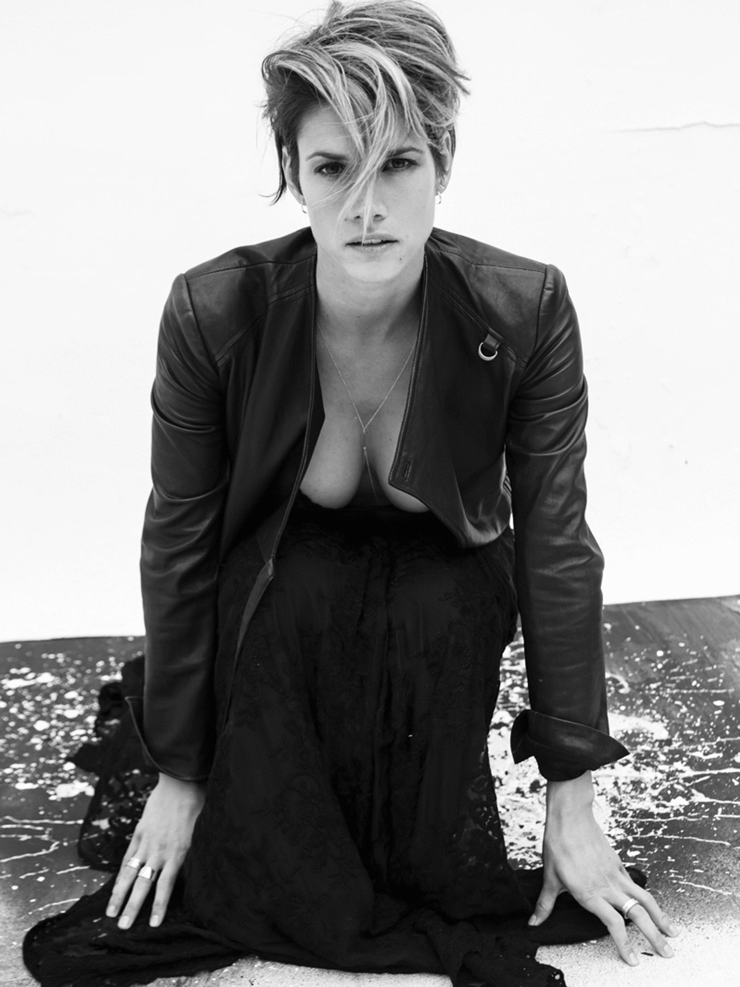Missy Peregrym in a leather jacket on a paint splattered surface