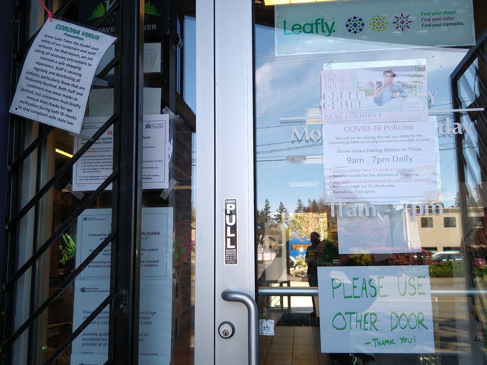 Signs in front of Green Lady West in Olympia West about online ordering and corona virus