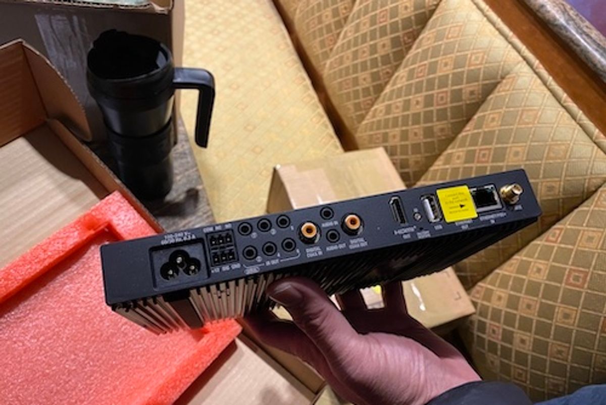 a photo of Control4 EA-3 Controller in a man's hand