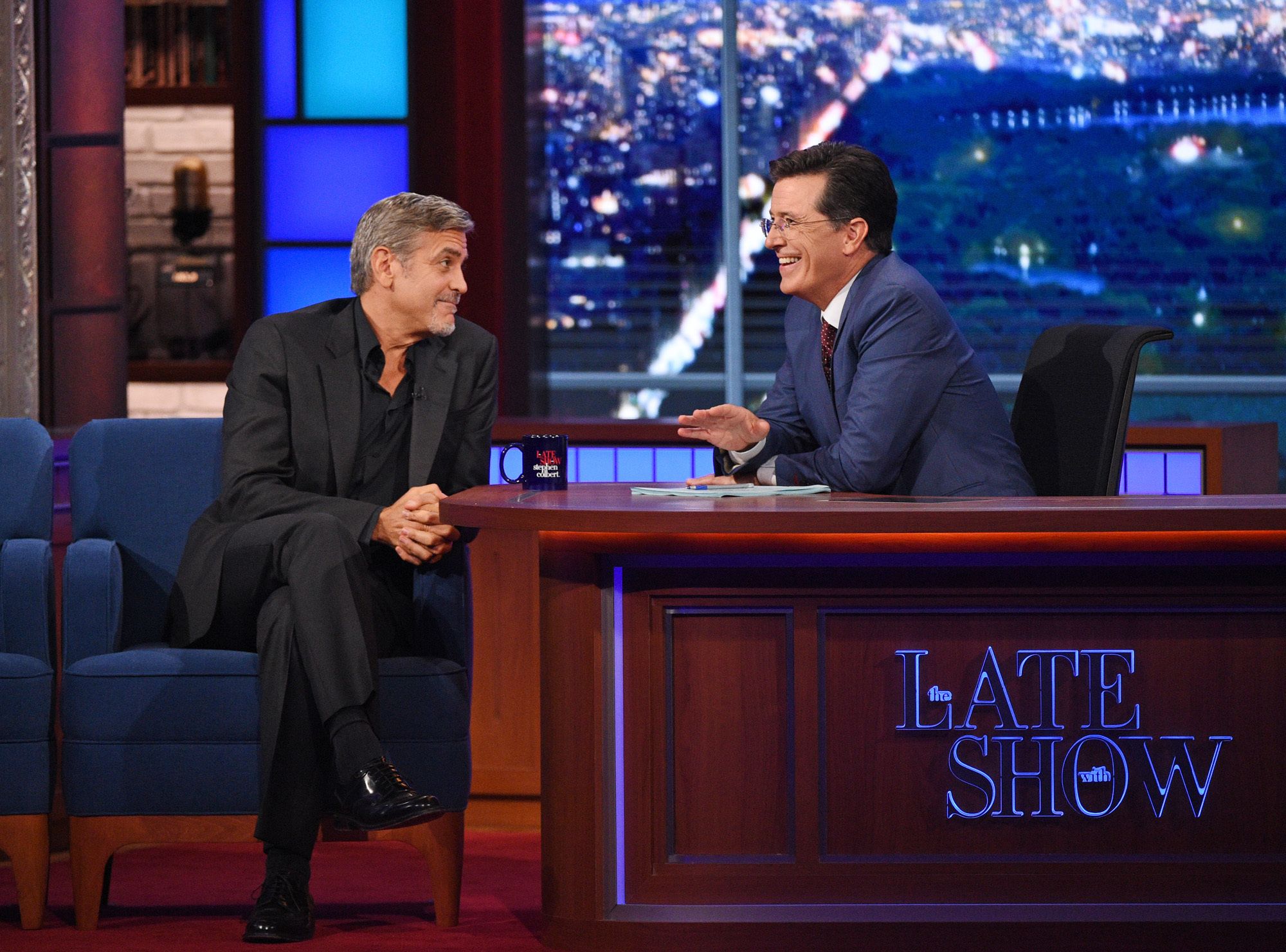 George Clooney faces Stephen Colbert on the set of The Late Show With Stephen Colbert