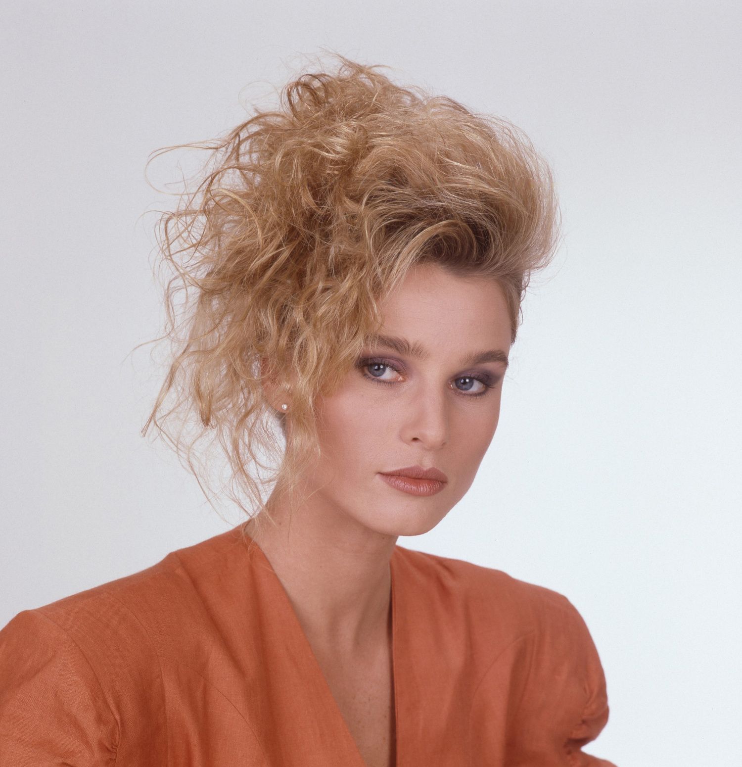 Nicollette Sheridan as Paige Matheson from the show Knots Landing wearing a top with large shoulderpads as was the style in the 1980s..