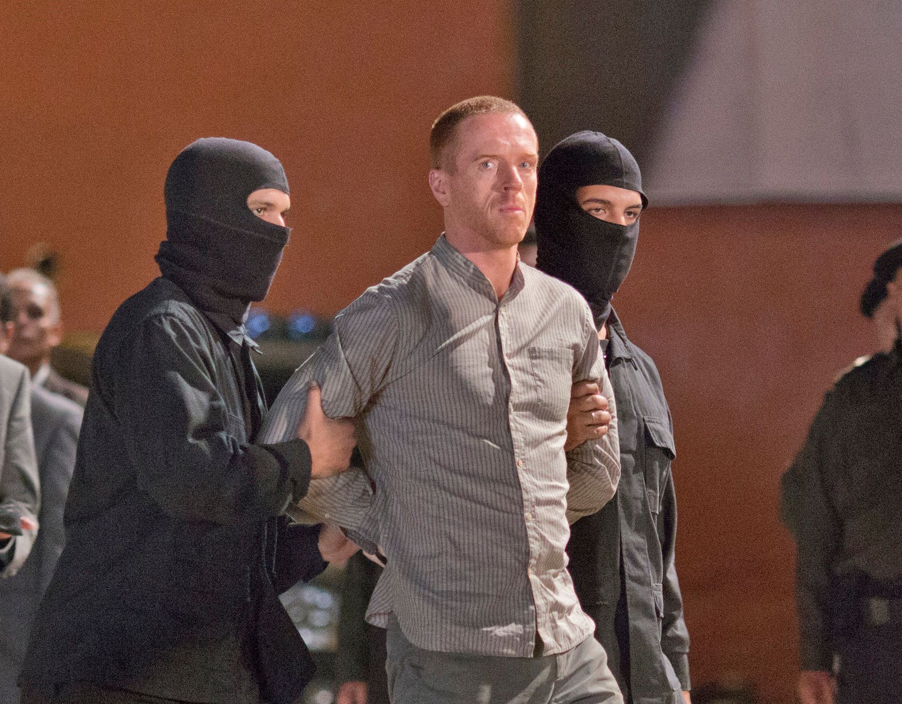 Damian Lewis as Nicholas Brody is being hauled to the gallows by two masked men in a scene from the show Homeland