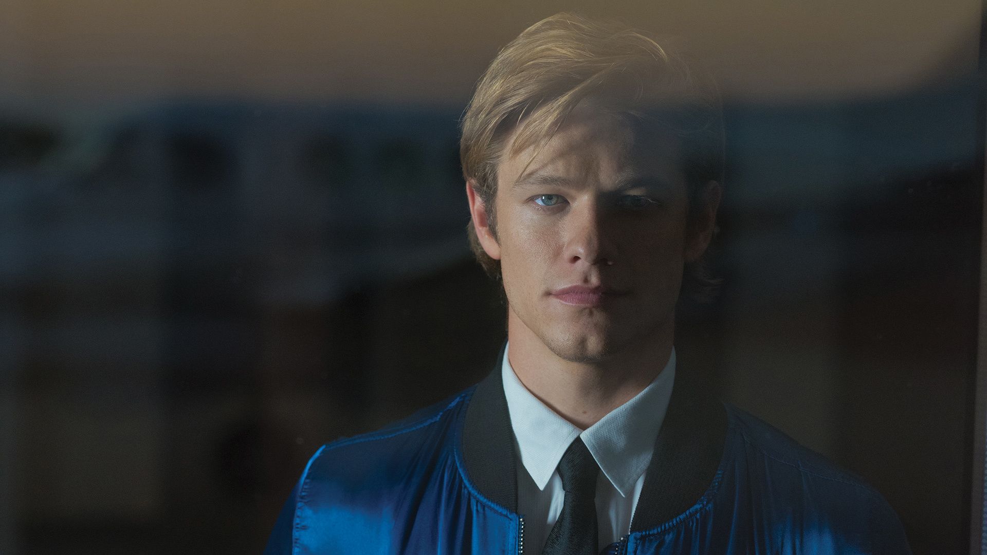 Lucas Till of MacGyver looks stoically at the camera