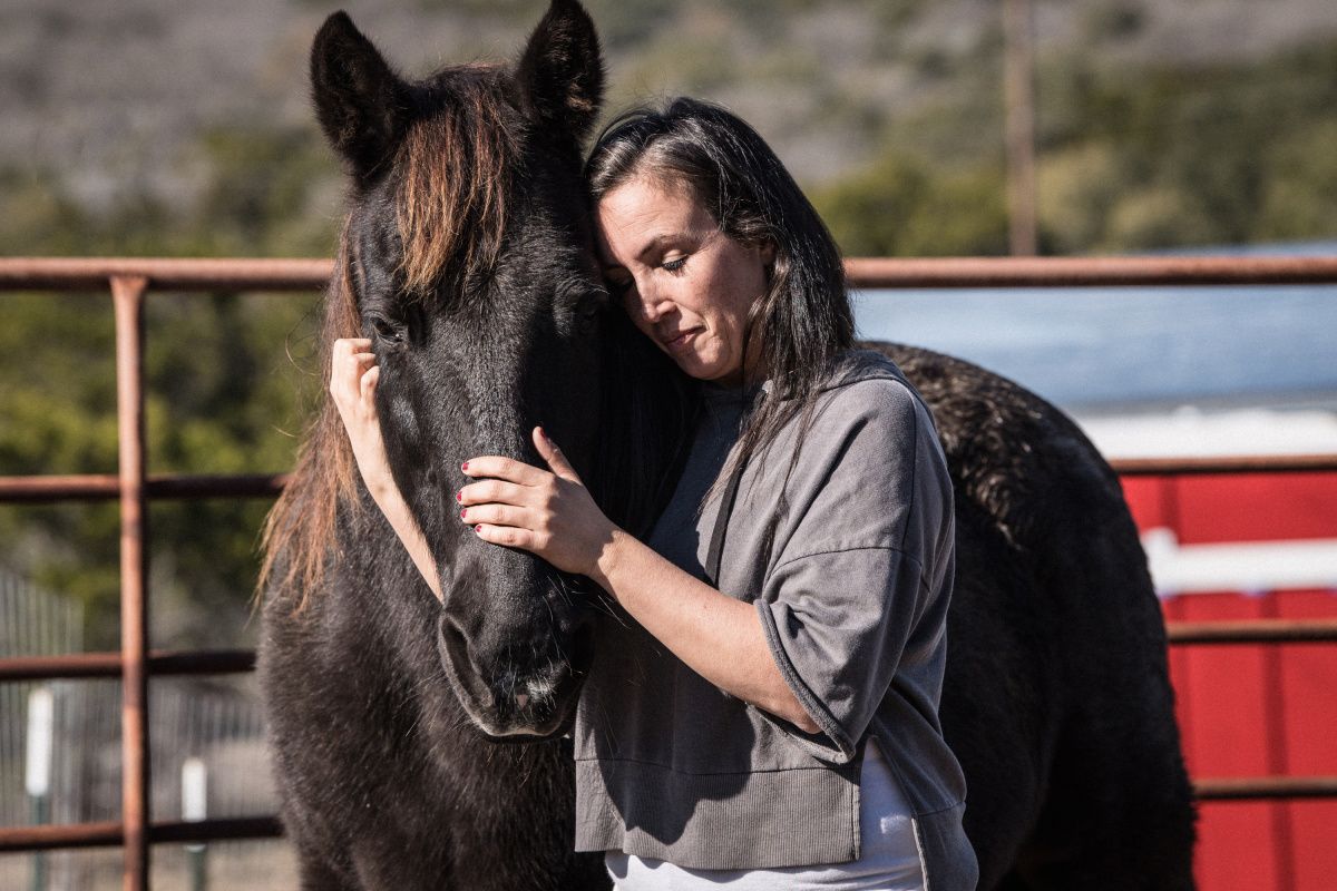 Woman hugging horse
