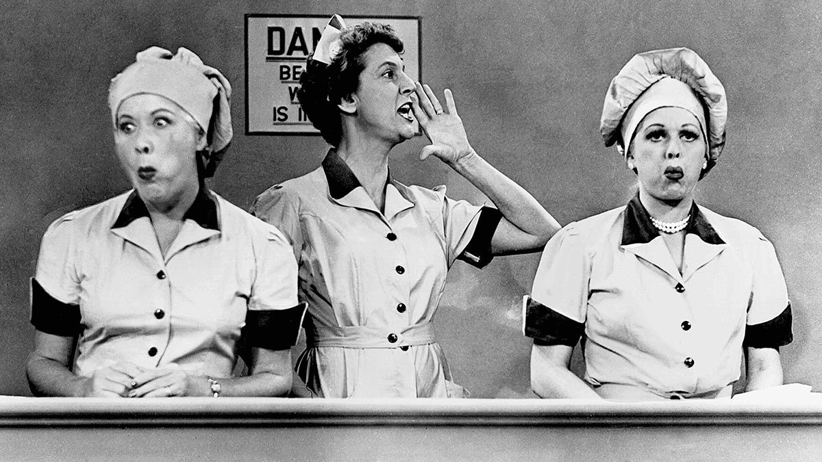 Ethel and Lucy stuff chocolates into their mouths
