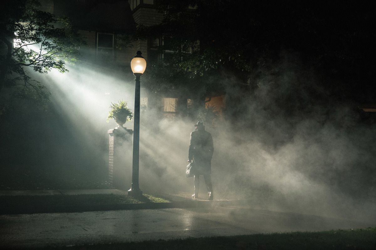 Man next to streetlight in foggy night