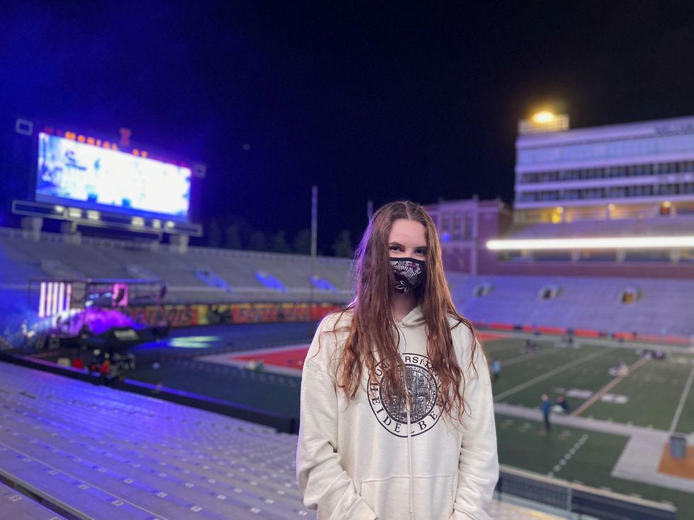 ​woman wears mask in a stadium