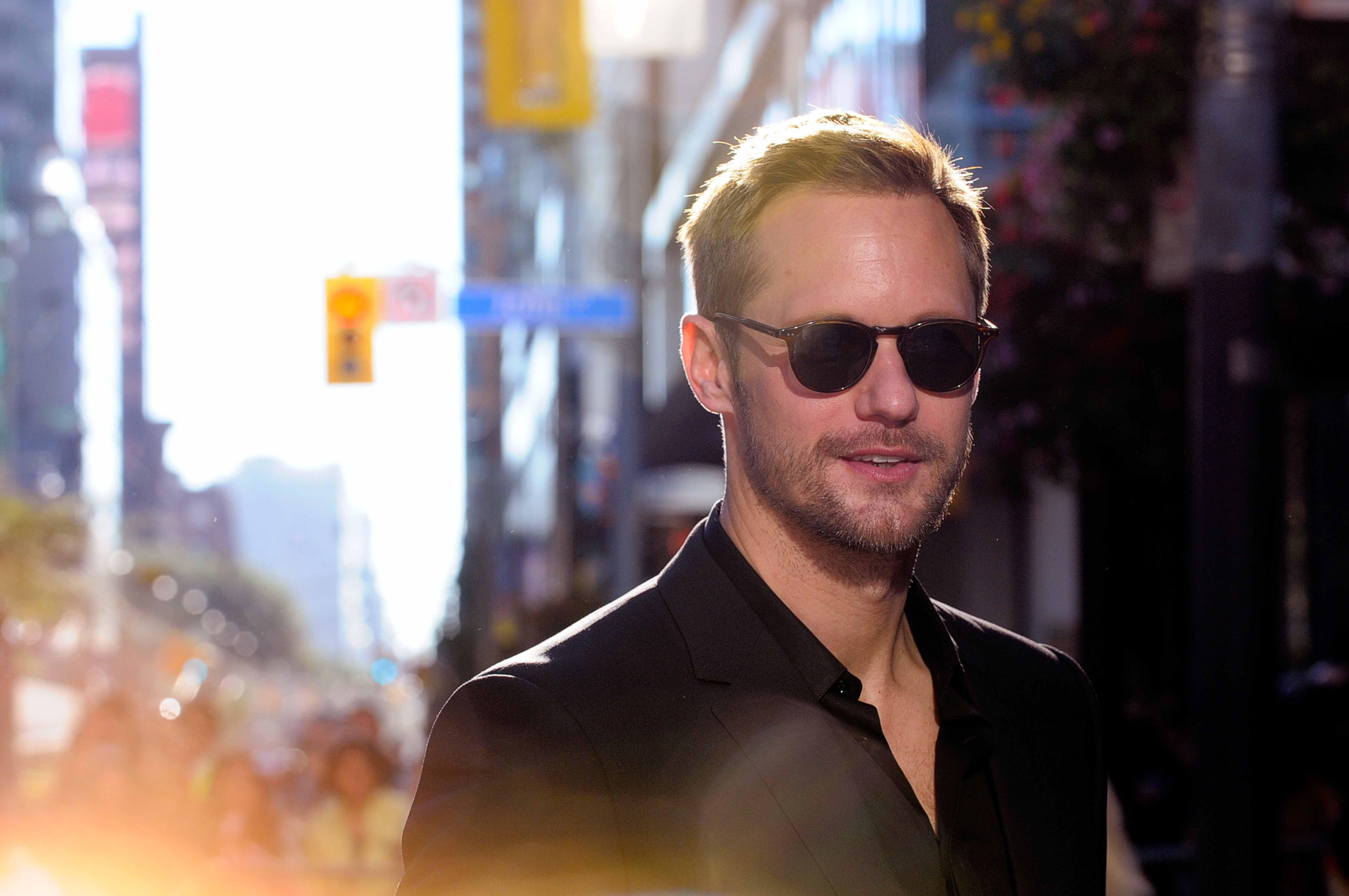 Alexander Skarsgard wearing sunglasses to a film premiere