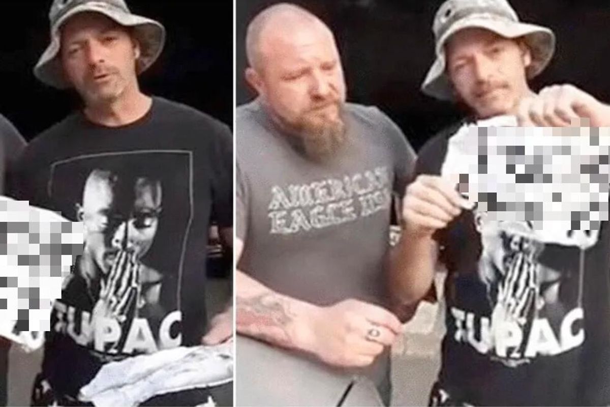 These two white 'working guys' holding racist signs is not at all what you're expecting