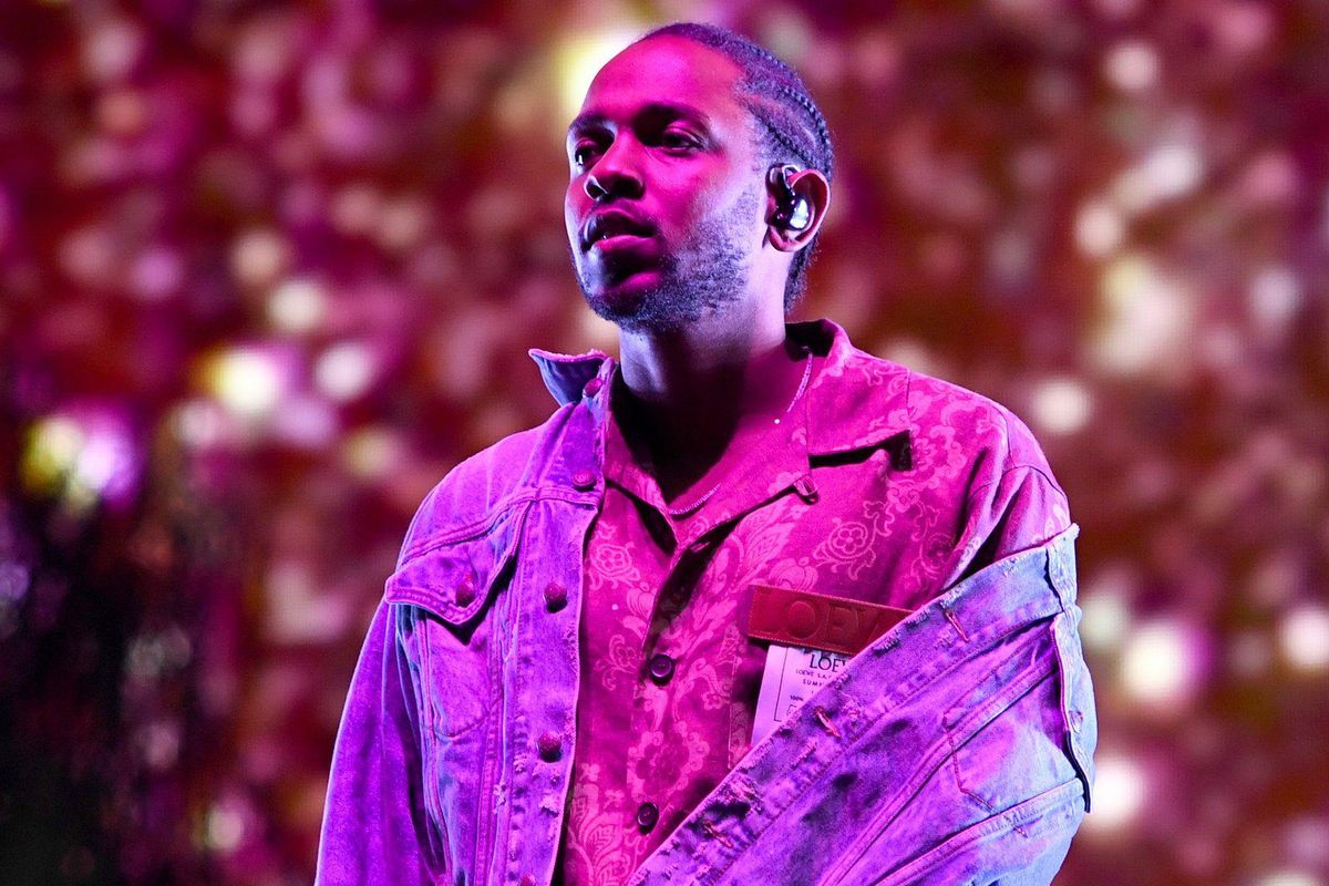 Kendrick Lamar on stage under purple lighting