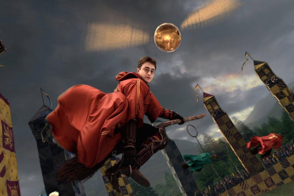Daniel Raddcliffe as Harry Potter playing quidditch