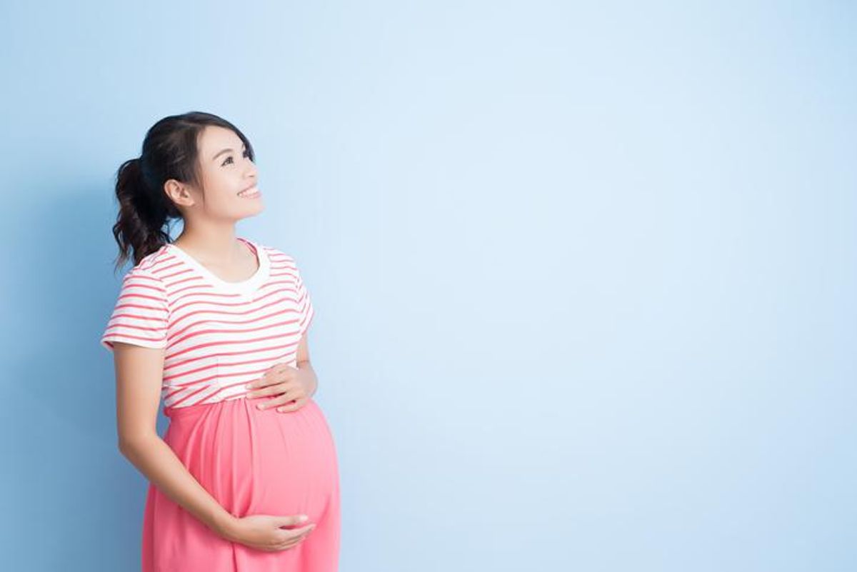 A woman, pregnant