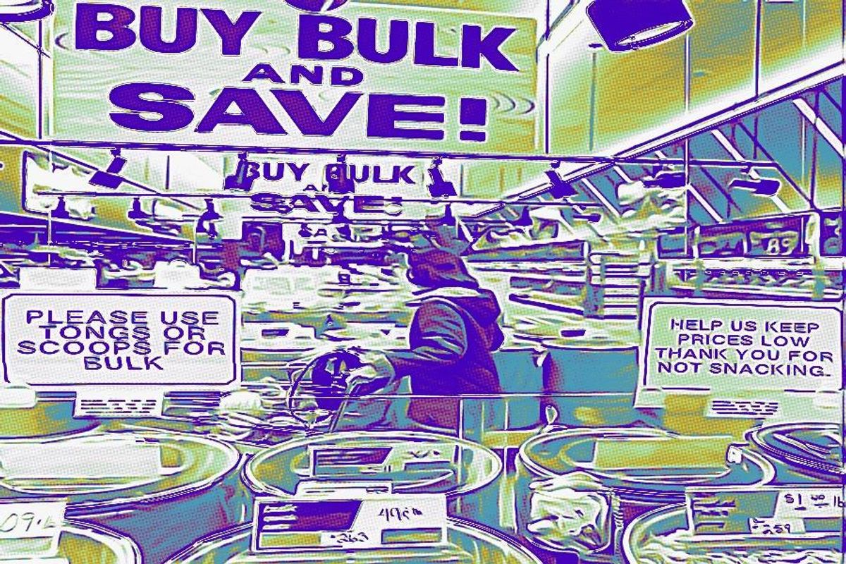 Woman pushing cart in store with many sigs reading "Buy Bulk And Save"