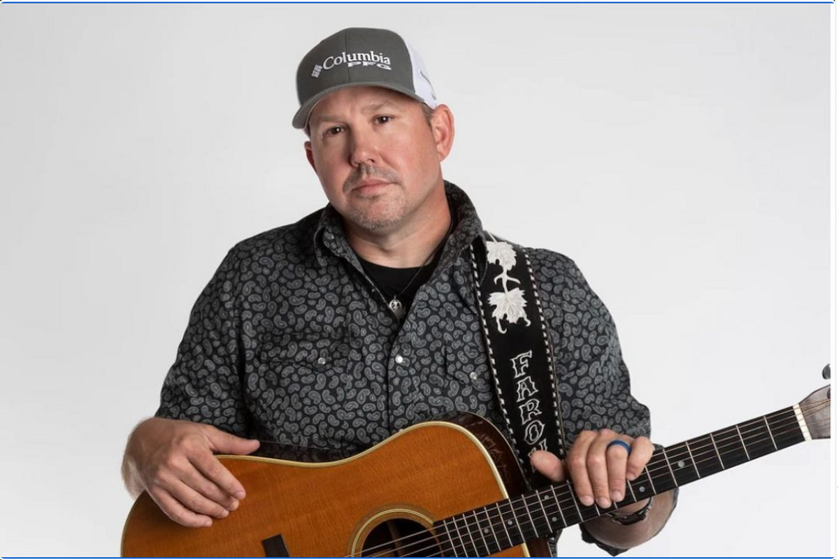 douchey looking man with guitar