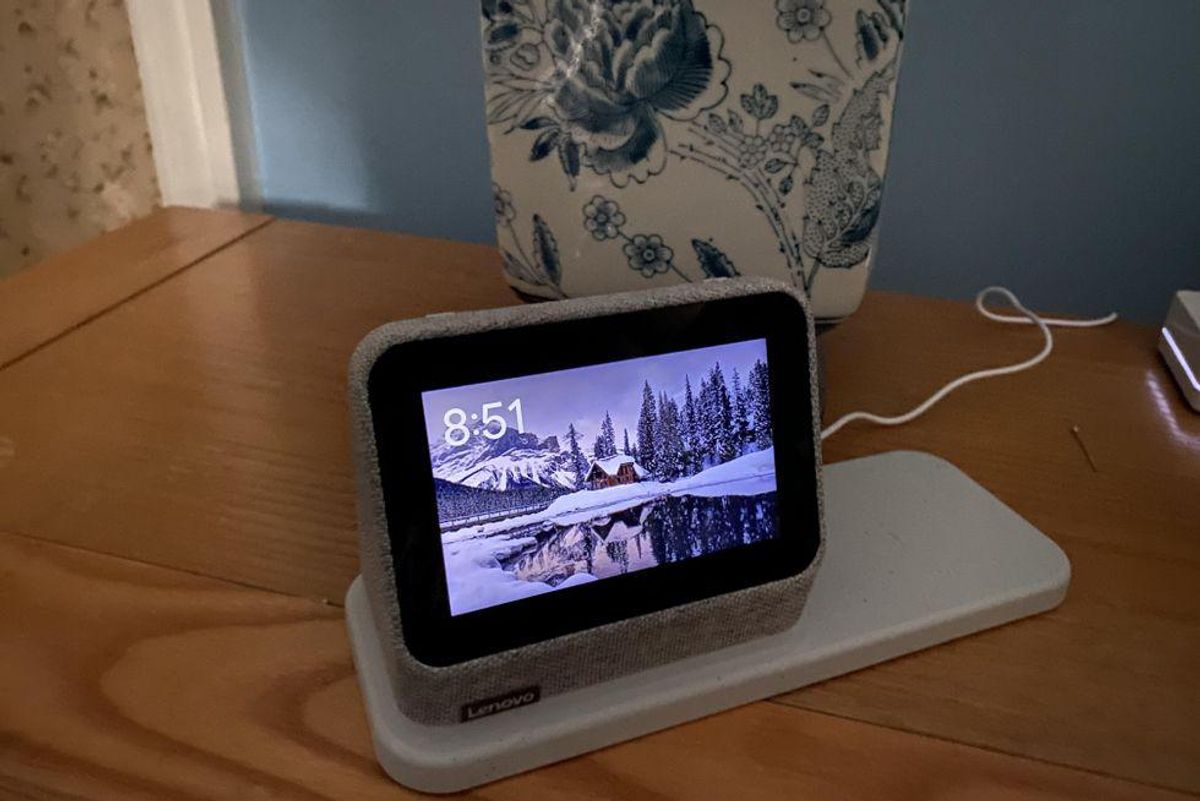 Lenovo Smart Clock Gen 2 with Charging Station and Google Assistant on a night stand.